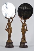 A pair of Art Deco style mid 20th century spelter figurines of ladies holding mirrors .