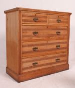 An Edwardian walnut 2 over 3 chest of drawers being raised on a plinth base with reeded 2 over 3