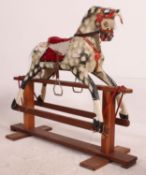 An early 20th century wooden rocking horse raised on pine glider in the manner of Lines.