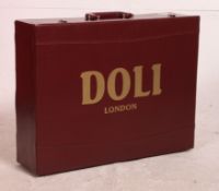 A burgundy leather suitcase with lined and appointed interior being marked for Doli of London.