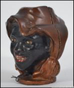 Vintage style retro Negroid cast metal painted money box. Measures: 10cm H.