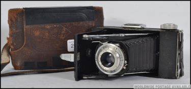 A vintage 20th century Agfa folding camera fitted with a Vario lens Cased . Measures: 18cm W.