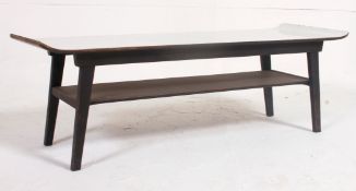 A vintage mid century long john coffee table of rectangular form with melamine top above.