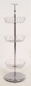 A retro 1970's chrome shop display stand having 3 basket graduating tiers with carry handle atop.