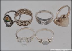A collection of 6 silver 925 / sterling rings to include fret pierced band ring, heart locket ring,