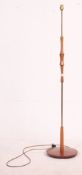 Retro vintage 1970's teak standard lamp with circular base and brass fittings. Measures: 137cm H.