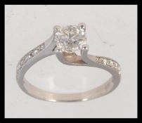 A contemporary tested 14ct white gold and diamond ladies ring having approx 65pts stone to centre
