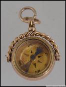 A hallmarked 9ct gold Victorian bloodstone and compass swivel watch fob with round bale and rope