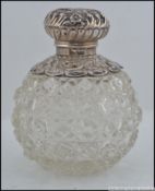 A late Victorian silver hallmarked and cut glass ladies dressing table perfume bottle.