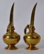 A pair of late 18th / early 19th century Indian long spouted temple oil ewers with anthropomorphic
