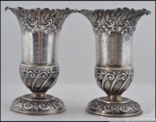 A pair of hallmarked silver vases in rococo with makers marks for Fenton Brothers Ltd,