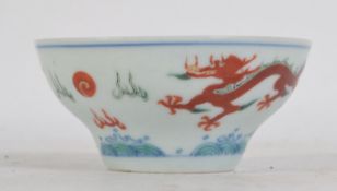 A Chinese blue and white rice bowl - finger bowl stylised with blue 4 claw dragons and sun to inner