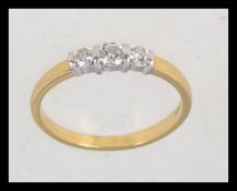 An 18ct gold 3 stone diamond ring, The round cut diamonds approx 20pnts. Hallmarked London.