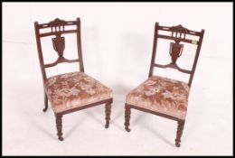 2 Edwardian mahogany nursing chairs being raised on turned legs with overstuffed seats and urn