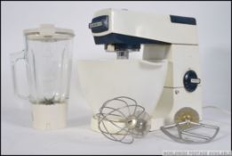 A vintage / retro Kenwood food mixer, complete with mixing bowl, K beater,