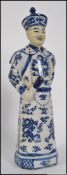 A 20th century ceramic figure of a Chinese scholar, in blue and white with character marks to base.