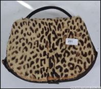A 1920's vintage ladies leopard skin handbag - clutch bag - muff combination with handle.