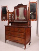 An Edwardian mahogany arts & crafts batwing dressing table chest of drawers.