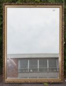 A 20th century large antique bevelled edge gilt mirror of rectangular form having original back