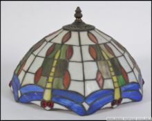 A 20th century Tiffany style leaded marbled and stained glass ceiling light shade along with