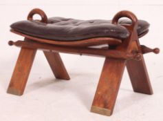 An anglo indian brass inlaid camel stool being well carved with a good quality leather button