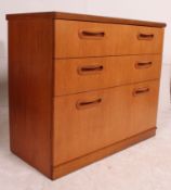 A 1970's Meredew teak sideboard having a straight 3 chest of drawers to the centre with recessed