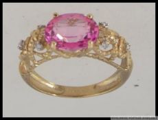 A hallmarked 9ct gold dress ring with large oval cut pink stone in a prong setting with with