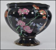 A 20th century Wood & Sons ' Formosa ' Staffordshire planter having black ground with foliate