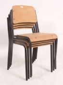 A set of 4 vintage Industrial stacking metal and panel wood chairs.