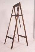 A large early 20th century artists easel stand of folding construction. Measures: 157cm x 75cm.