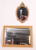 An ornate moulded gilt framed early 20th century mirror along with another gilt rectangular mirror.