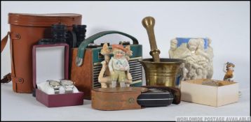 A collection of items to include a pair of 20th century binoculars, his and hers matching watches,