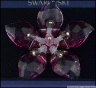 Swarovski boxed crystal brooch in floral form.