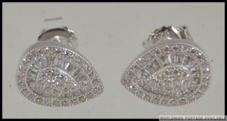 A pair if silver and CZ pear shaped ear studs