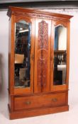 An Edwardian mahogany arts and crafts double wardrobe having plinth base with drawer and double