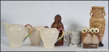 A collection of ceramics to include a God Speed The Plough twin handled loving cup, a Chinese vase,