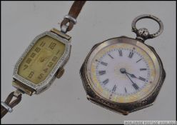 A continental silver 935 marked ladies open faced fob pocket watch with decorative gilded borders,