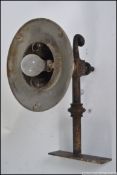 An Industrial 20th century dairy lamp - factory outside yard fitting with cast iron bracket with