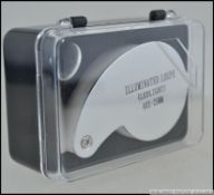 A new and unused cased Jewellers loupe having metal surround and good magnification.