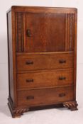 A 1930's Art Deco oak tallboy having shaped bracket legs with 3 drawers under single cupboard.