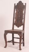 A 19th century Jacobean revival carved oak hall chair having cabriole legs with stretchers under