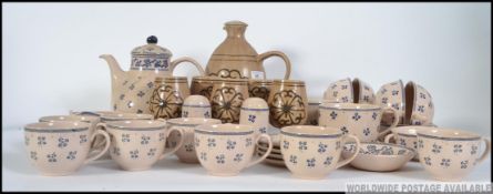 A large collection of blue and cream glazed tea service to include the teapot together with a