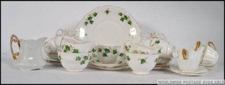 A vintage Colclough Staffordshire ceramic china tea service in the Ivy pattern, consisting of cups,