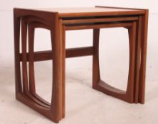 A retro 1970's G-Plan Kelso Nest of table in teak raised on squared supports having graduating tops