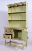 A vintage 1930's painted oak shabby chic welsh dresser raised on turned supports with cupboards and