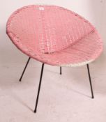 A 1960's plastic rattan weave atomic sputnik bedroom tub chair in pink and white raised on black