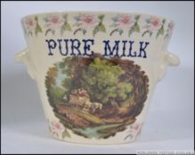 A fabulous large Continental pottery twin handled milk pail,
