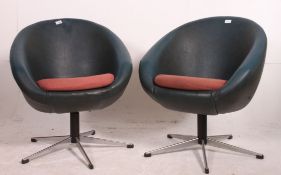 A retro 1970's pair of swivel egg chairs having the original vinyl upholstery and raised on chrome