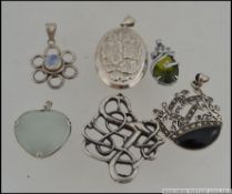 A collection of 5 silver 925 / sterling marked necklace pendants to include oval locket,