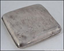 A silver hallmarked cigarette case with central monogram.